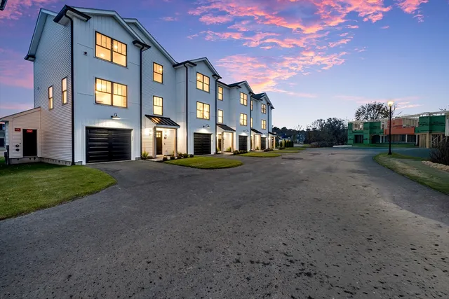 a front view of a brick house with a yard