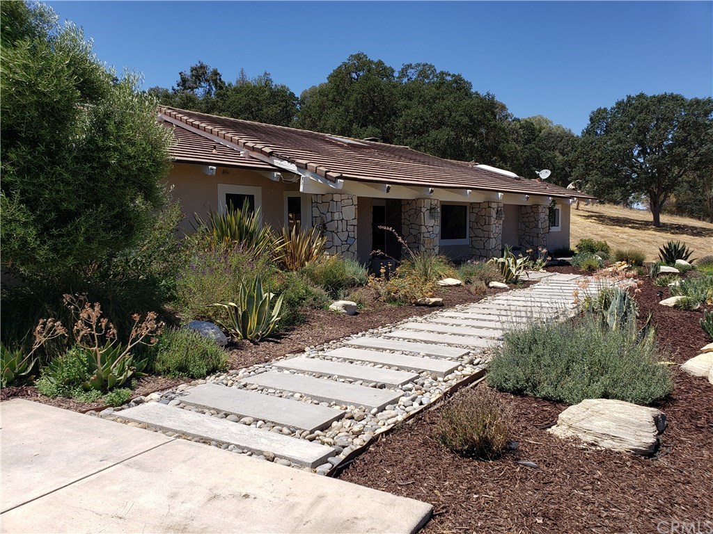Custom pavers lead to the front entrance.