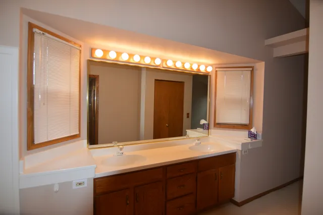 a bathroom with a double vanity sink and a mirror