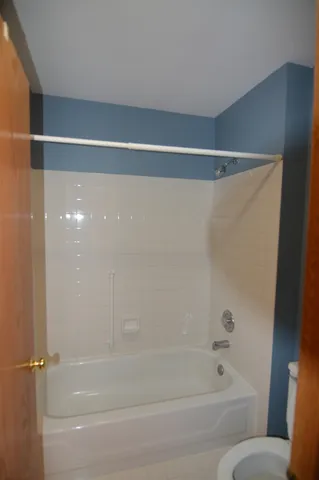 a bathroom with a shower and a bath tub