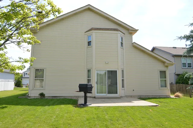 a front view of house with a garden and yard