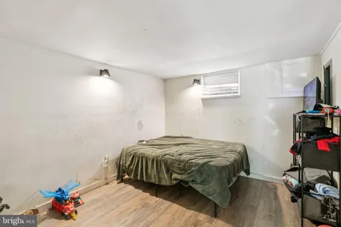 a bed sitting in a bedroom next to a window
