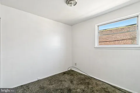 a view of a room with a ceiling fan and a window