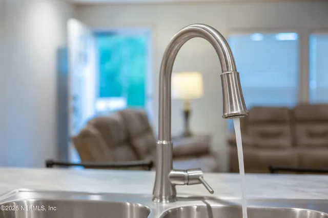 a kitchen with white cabinets and appliances