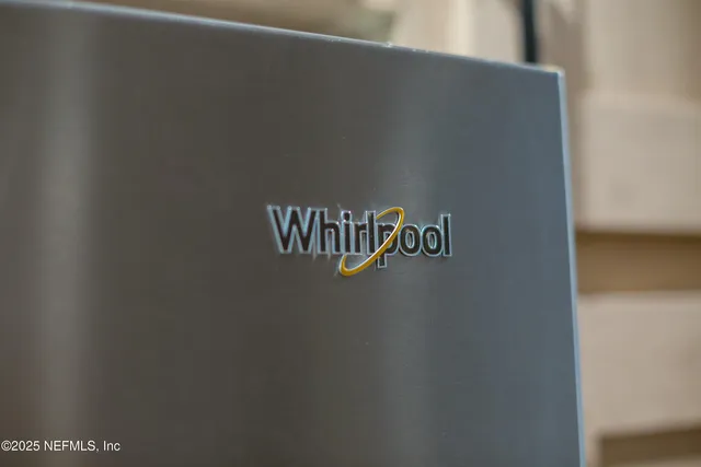 a kitchen with stainless steel appliances granite countertop a sink a stove and a wooden floors