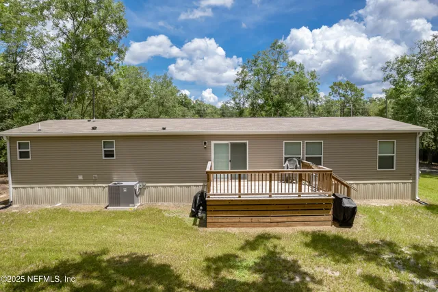 aerial view of a house with a yard and furniture
