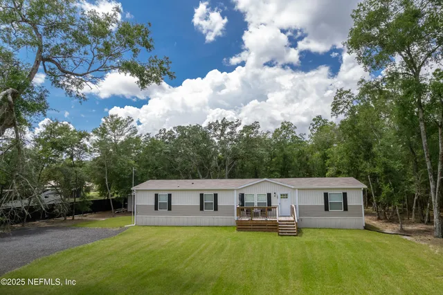 a front view of house with yard and green space