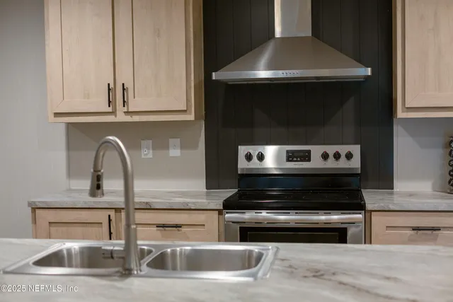 a kitchen with granite countertop a stove and a sink