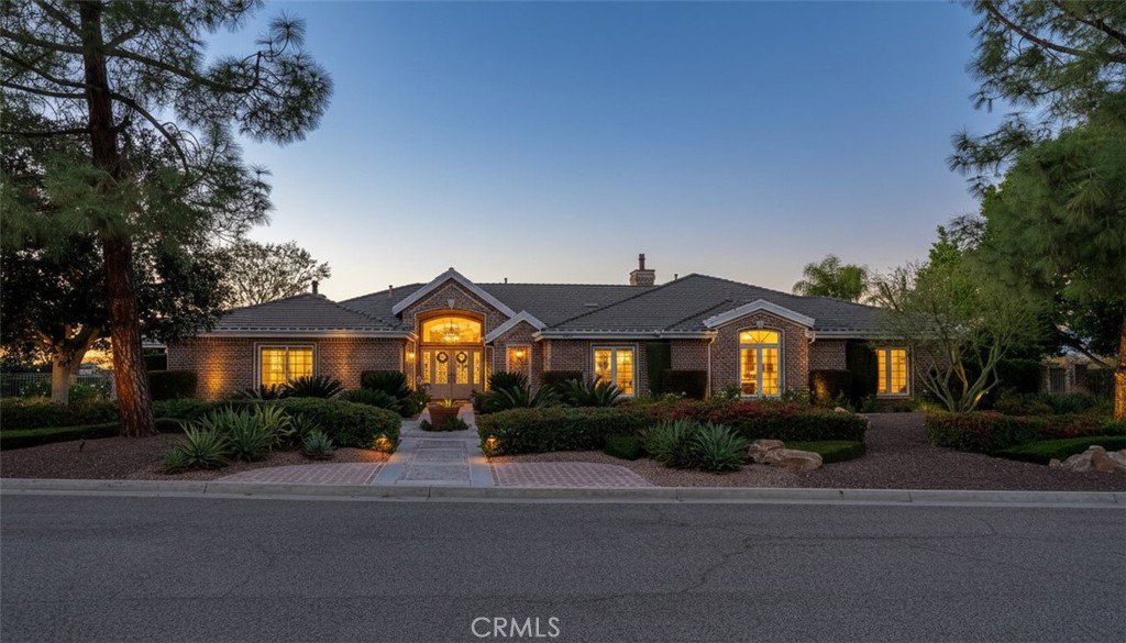 a front view of a house with a yard and potted plants
