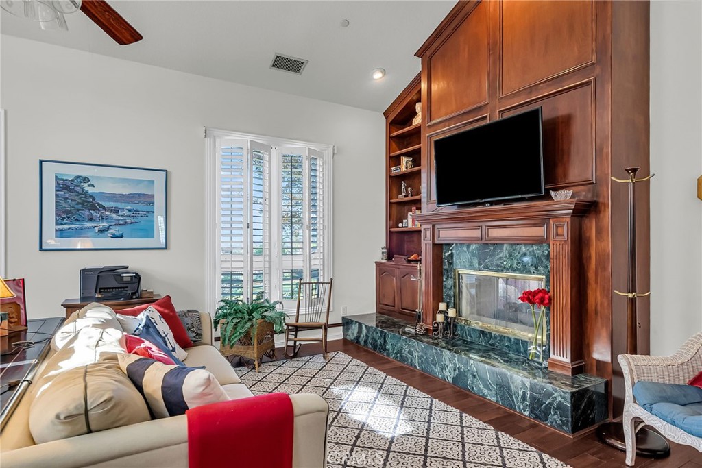 6872 Chartwell Drive Riverside, CA 92506 - Photo 15 of 51 a living room with furniture a flat screen tv and a fireplace