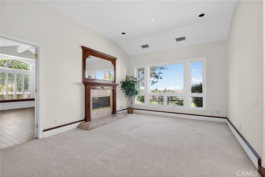 6872 Chartwell Drive Riverside, CA 92506 - Photo 16 of 75 an empty room with windows and way to kitchen