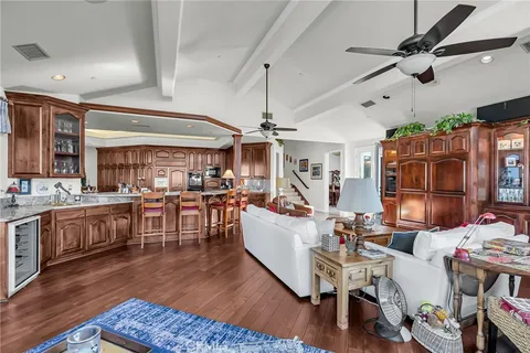 a living room with lots of furniture and kitchen view