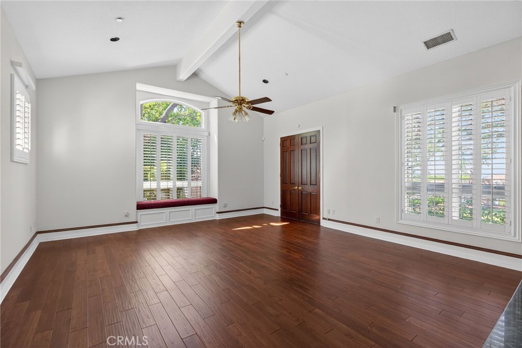 6872 Chartwell Drive Riverside, CA 92506 - Photo 18 of 75 a view of an empty room with wooden floor and a window