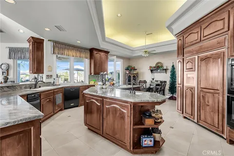 a kitchen with kitchen island granite countertop lots of counter top space and stainless steel appliances
