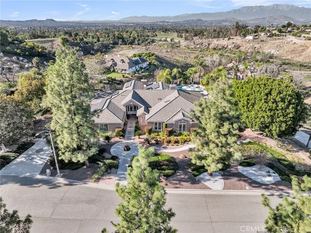 an aerial view of a house with a yard