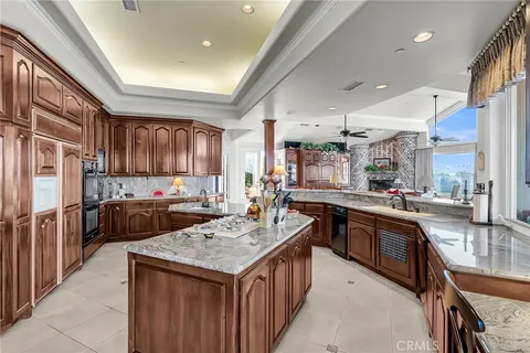 a kitchen with stainless steel appliances granite countertop a sink a stove and a refrigerator