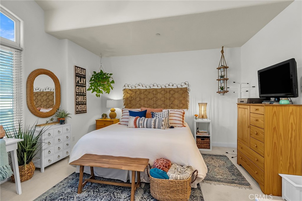 6872 Chartwell Drive Riverside, CA 92506 - Photo 29 of 51 a bedroom with a bed a mirror on dresser and a flat screen tv