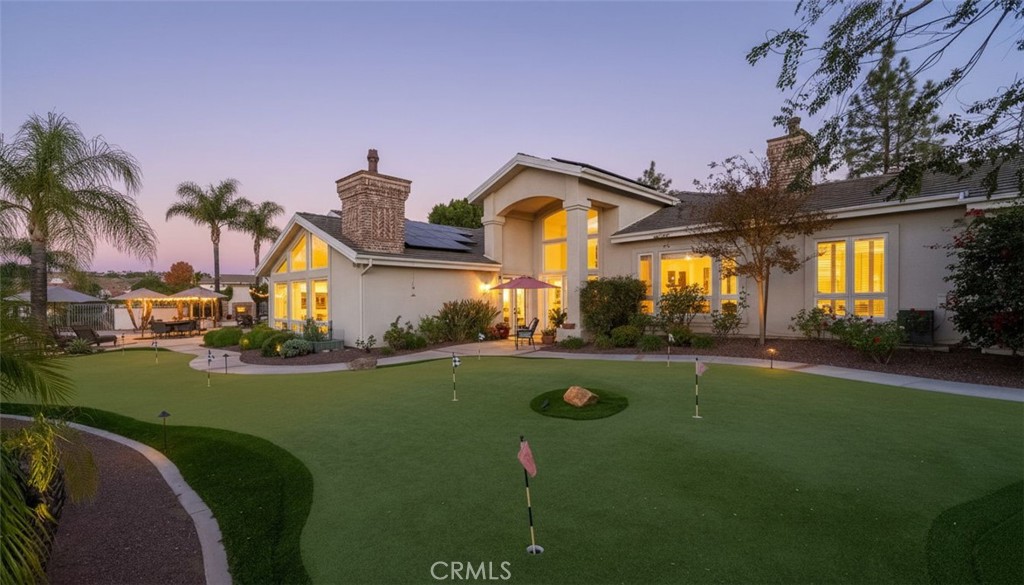 6872 Chartwell Drive Riverside, CA 92506 - Photo 30 of 51 a front view of a house with a yard and garage
