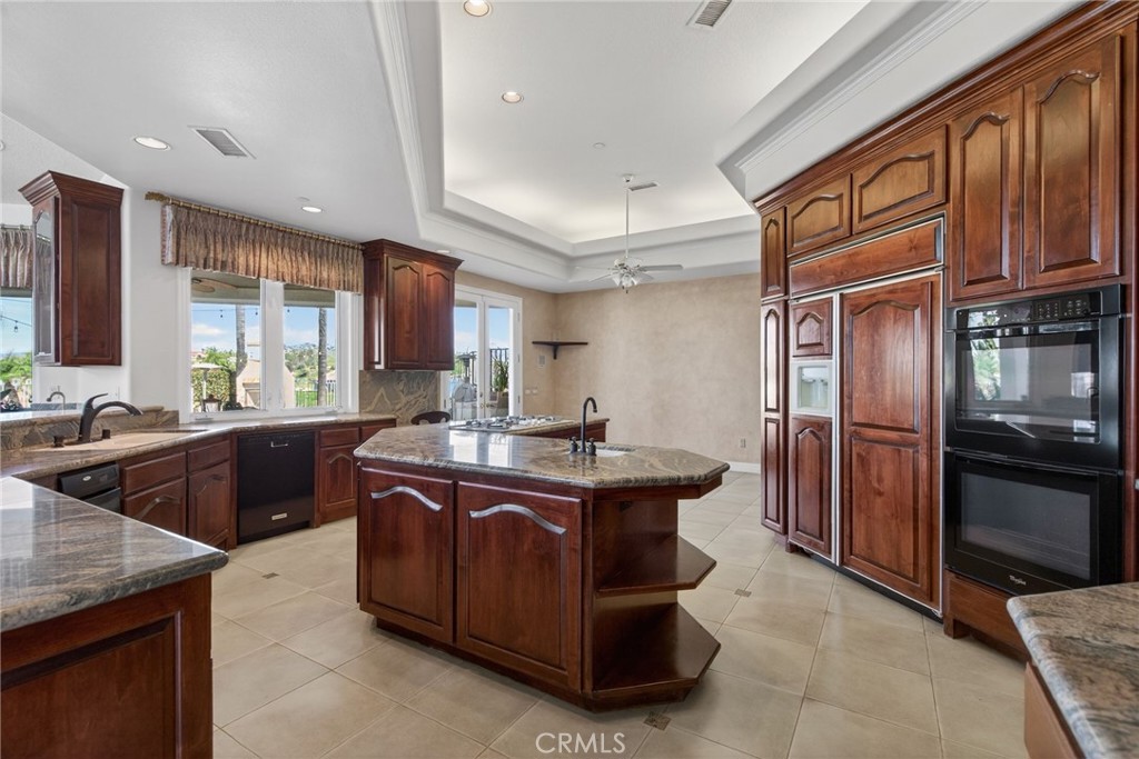 6872 Chartwell Drive Riverside, CA 92506 - Photo 31 of 75 a kitchen with stainless steel appliances granite countertop a sink stove and refrigerator