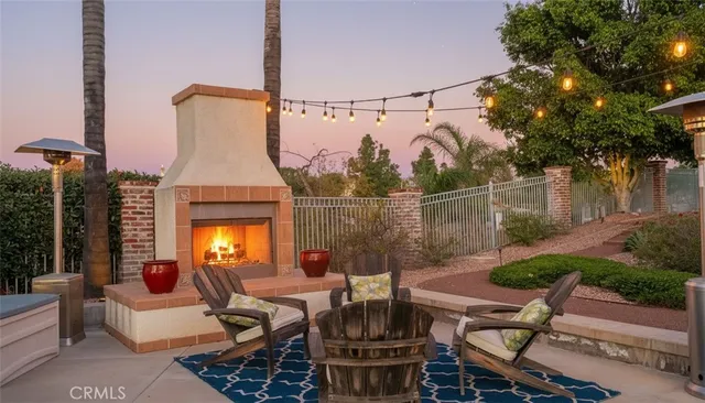 a view of a patio with couches table and chairs and potted plants