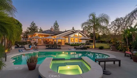 a view of a swimming pool with a patio and a yard