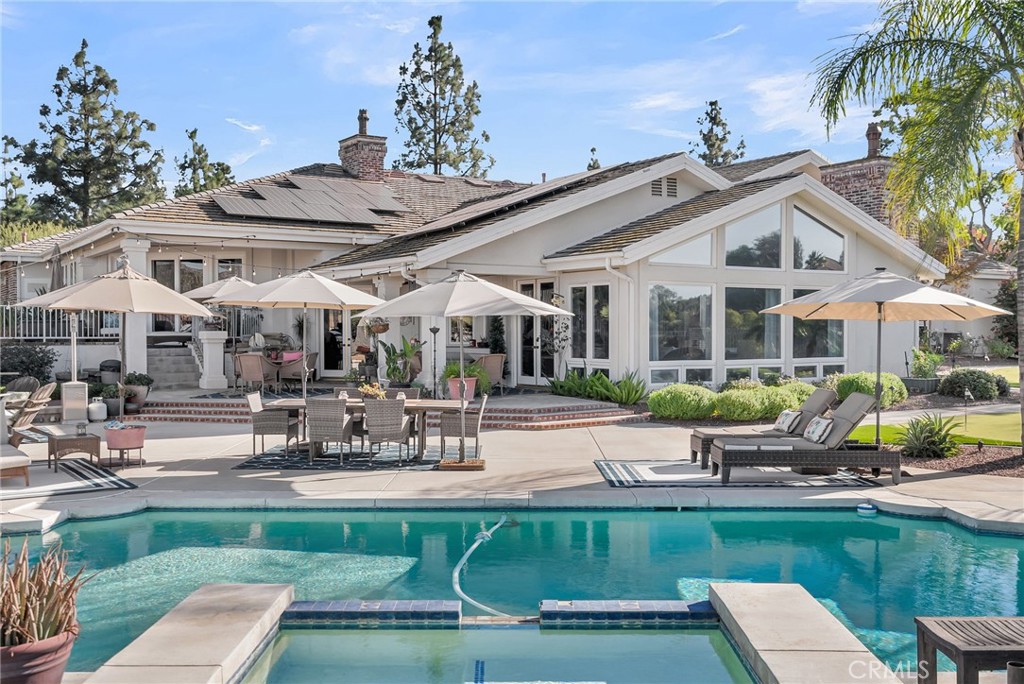 6872 Chartwell Drive Riverside, CA 92506 - Photo 35 of 51 a view of a white house with a patio table and chairs