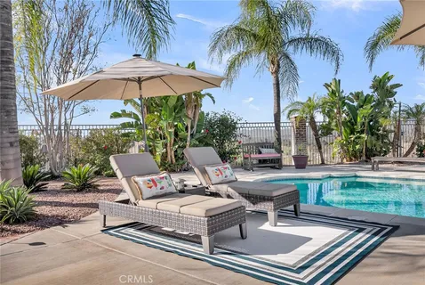 a view of backyard with outdoor seating and trees