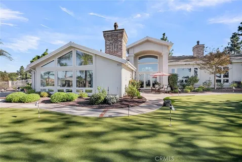 a front view of house with outdoor space and swimming pool