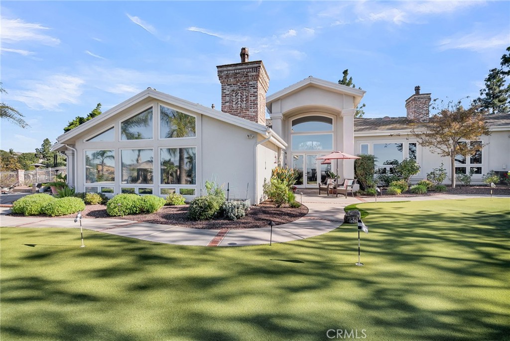 6872 Chartwell Drive Riverside, CA 92506 - Photo 41 of 51 a front view of house with outdoor space and swimming pool