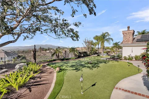 a view of a swimming pool with a lawn chairs under an umbrella