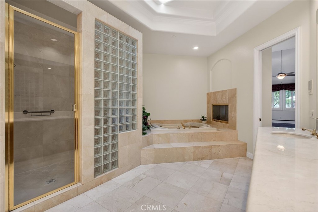 6872 Chartwell Drive Riverside, CA 92506 - Photo 44 of 75 a bathroom with a tub and a shower