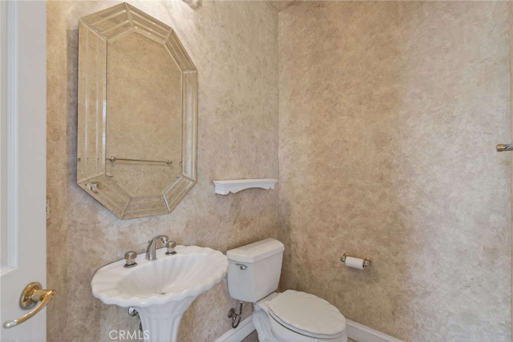 6872 Chartwell Drive Riverside, CA 92506 - Photo 45 of 75 a bathroom with a sink mirror and toilet