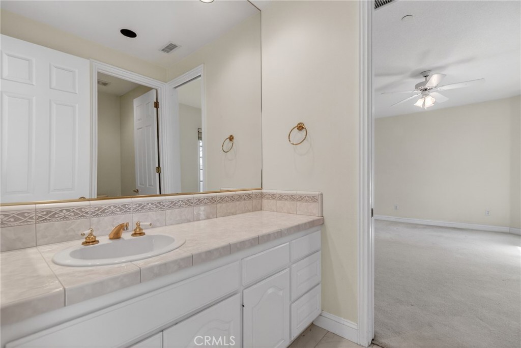 6872 Chartwell Drive Riverside, CA 92506 - Photo 48 of 75 a bathroom with a sink and a mirror