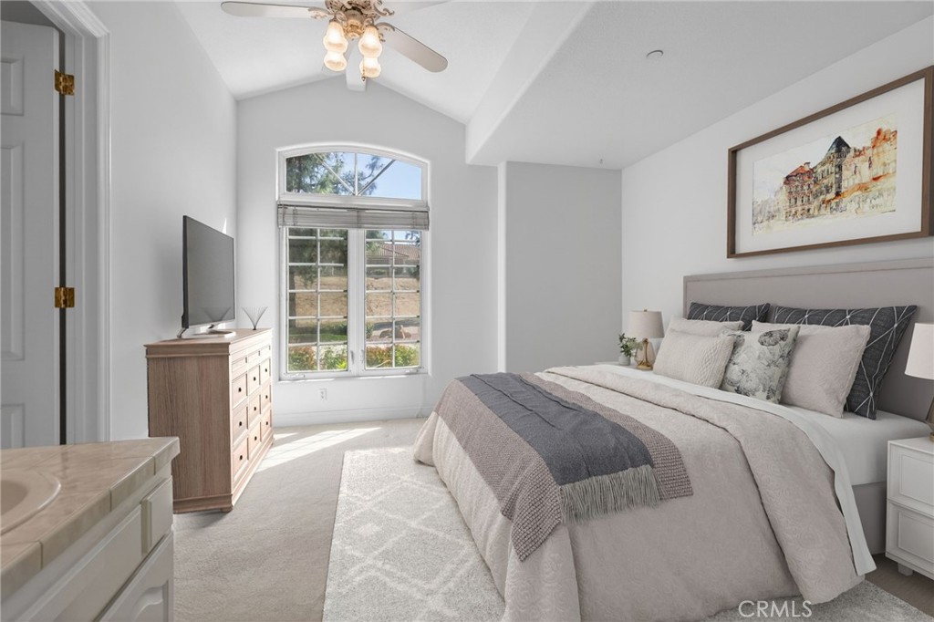 6872 Chartwell Drive Riverside, CA 92506 - Photo 51 of 75 a spacious bedroom with a large bed and a chandelier
