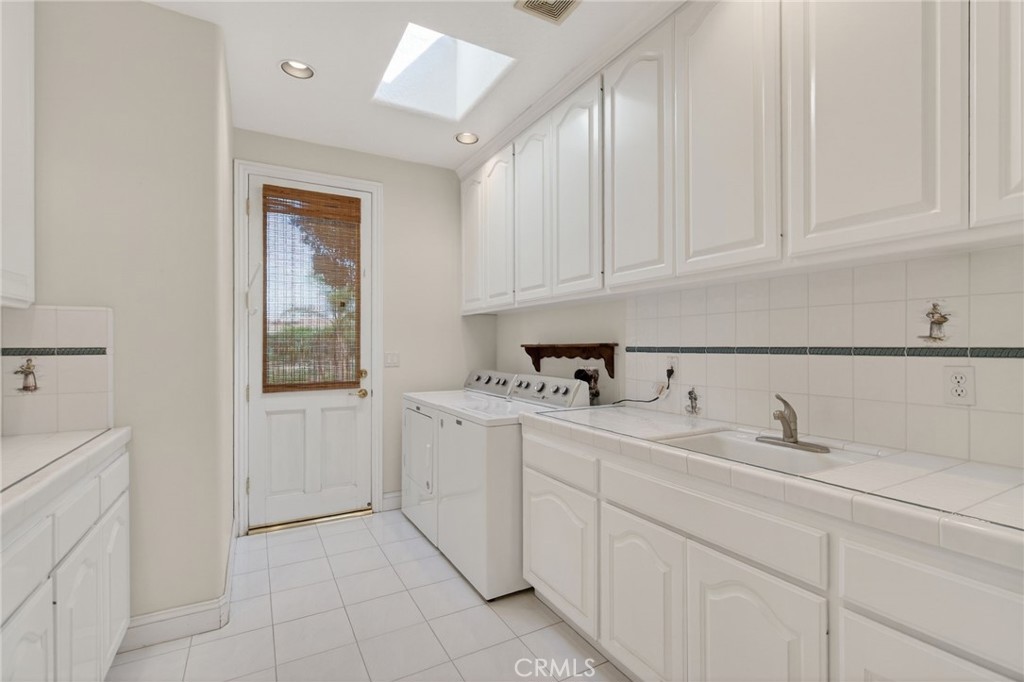 6872 Chartwell Drive Riverside, CA 92506 - Photo 55 of 75 a kitchen with white cabinets and sink