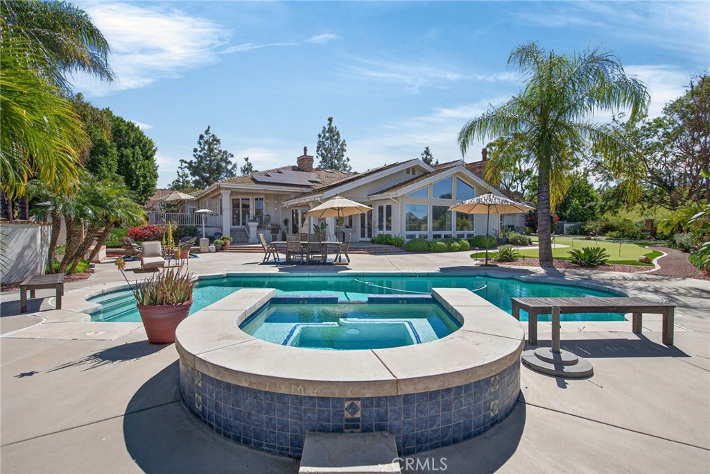 6872 Chartwell Drive Riverside, CA 92506 - Photo 58 of 75 a view of swimming pool with outdoor seating and trees in the background
