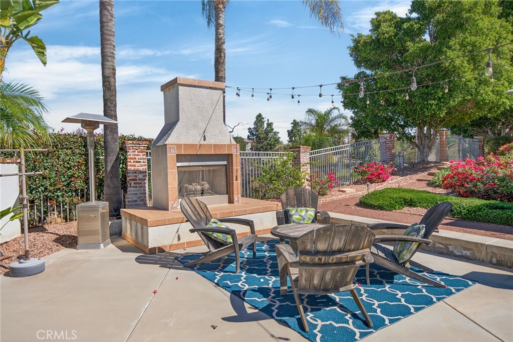 6872 Chartwell Drive Riverside, CA 92506 - Photo 60 of 75 a view of a patio with table and chairs potted plants and palm tree