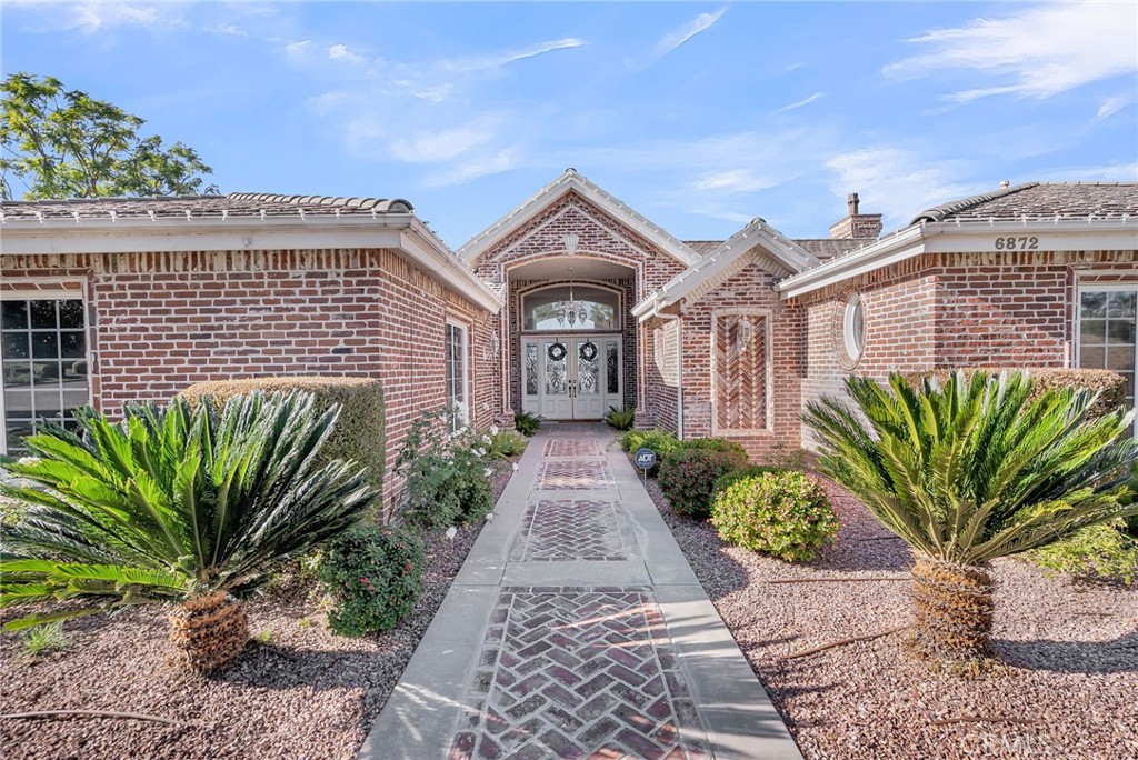 6872 Chartwell Drive Riverside, CA 92506 - Photo 7 of 51 a front view of a house with a garden