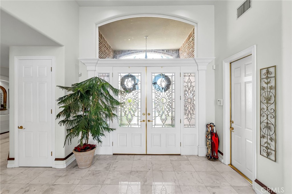 6872 Chartwell Drive Riverside, CA 92506 - Photo 9 of 51 an entryway with wooden floor and a potted plant
