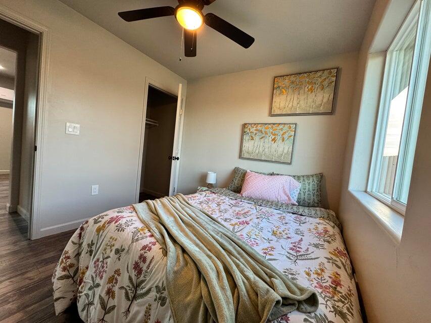 177 South Callison Road Tipton, CA 93272 - Photo 8 of 18 a bedroom with a large bed and a chandelier