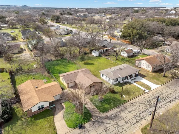 an aerial view of a house with garden space and ocean view