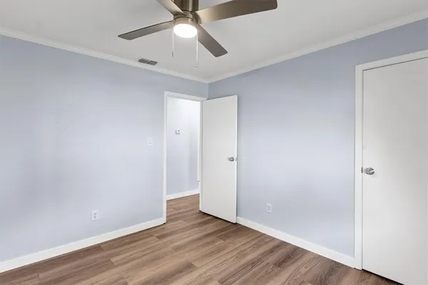 a view of an empty room with wooden floor