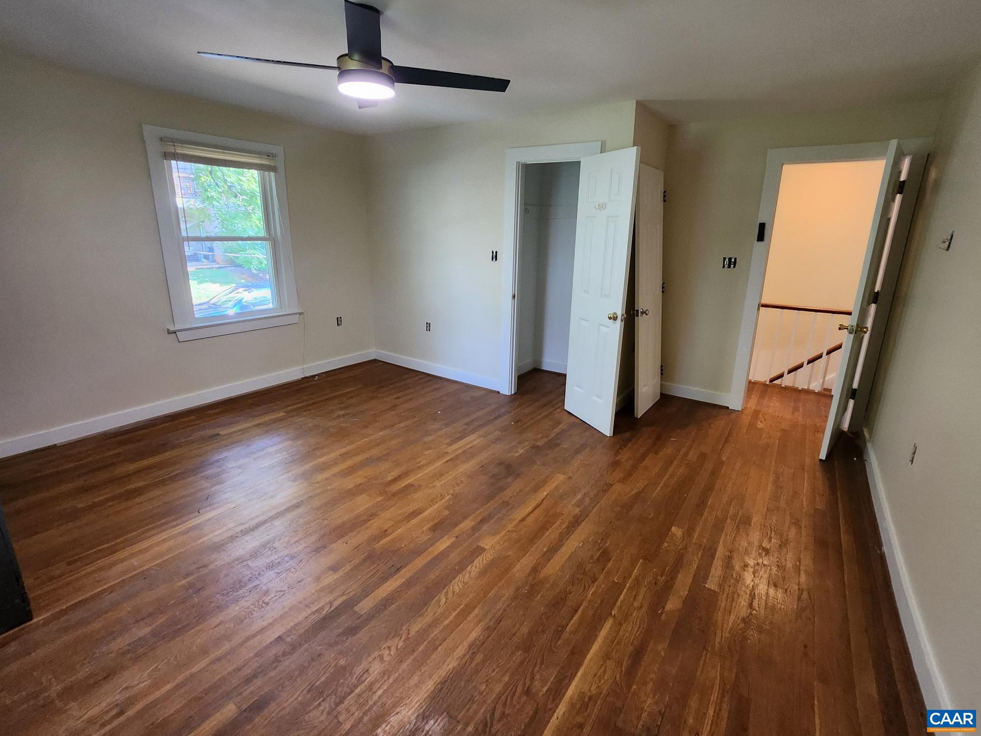 142 Carlton Road, Unit B Charlottesville, VA 22902 - Photo 11 of 13 wooden floor in an empty room with a window