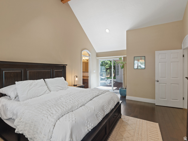 13357 Trail Rider Circle Draper, UT 84020 - Photo 27 of 70 Vaulted ceiling with exposed wood beam, dark wood-finish flooring, sliding glass door access to a patio, and an arched entry