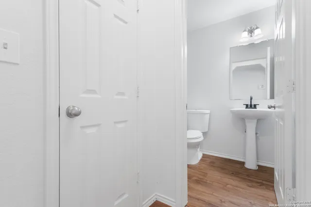 a white toilet sitting next to a bathroom sink