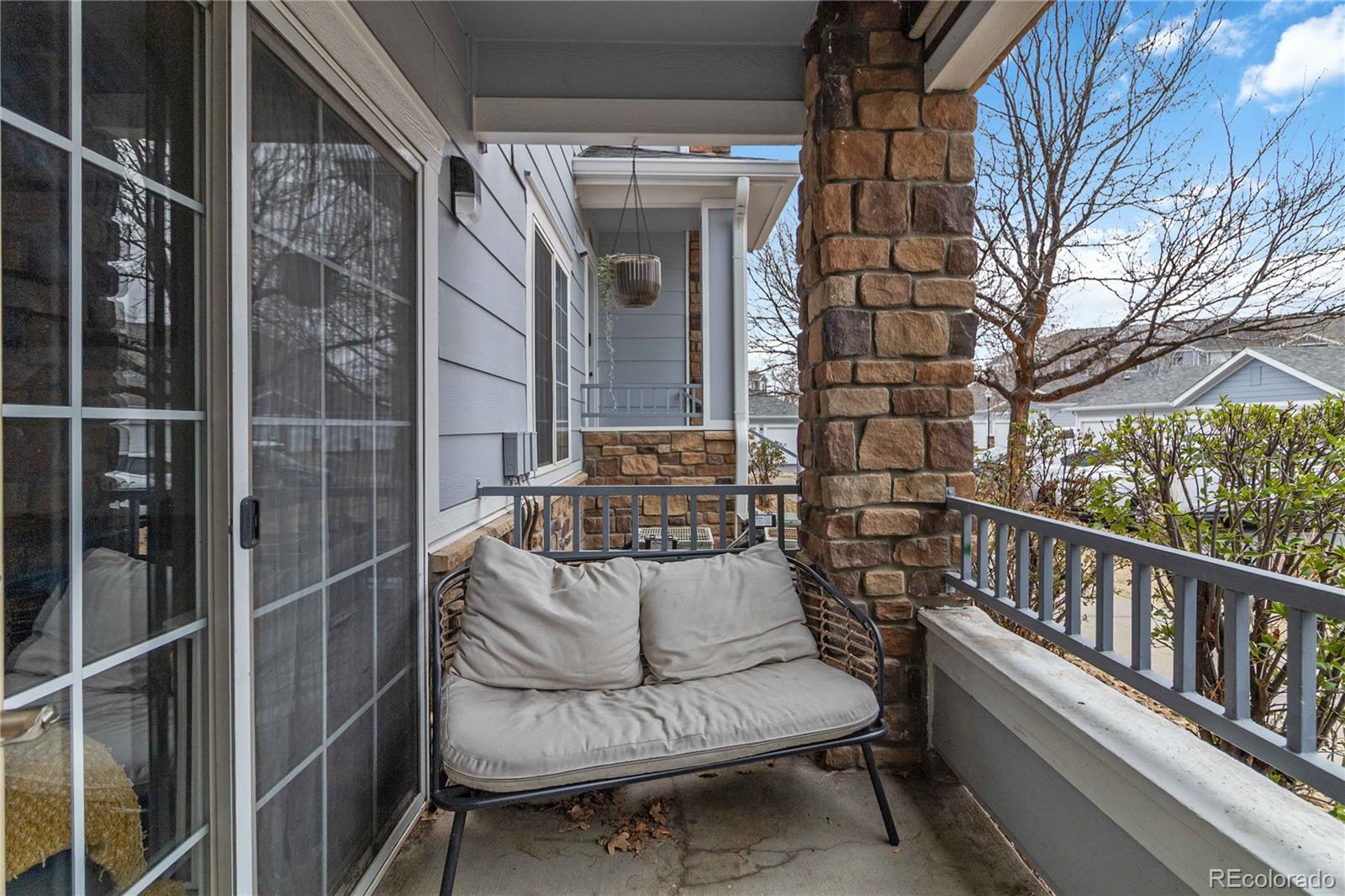 5255 Memphis Street, Unit 702 Denver, CO 80239 - Photo 21 of 30 a view of balcony with two chairs and a potted plant