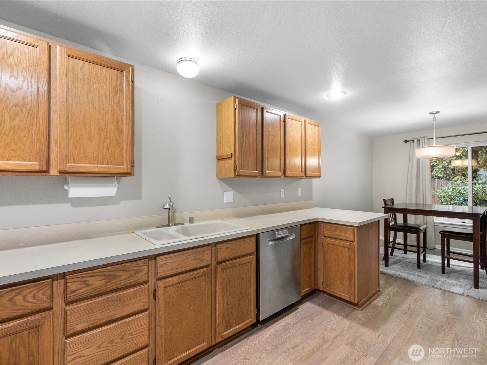 21227 76th Avenue West, Unit B8 Edmonds, WA 98026 - Photo 14 of 29 a kitchen with sink cabinets and window