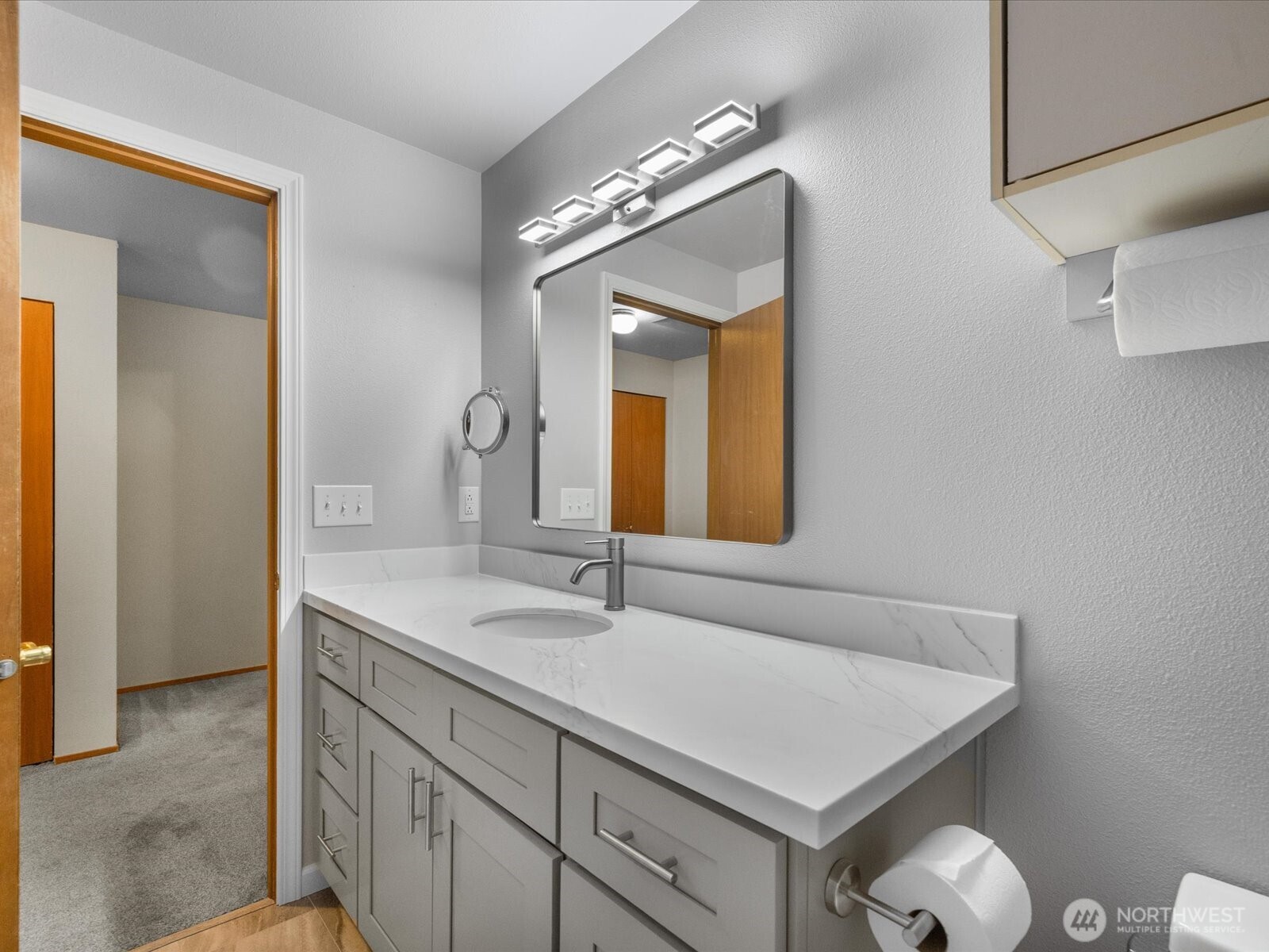 21227 76th Avenue West, Unit B8 Edmonds, WA 98026 - Photo 25 of 29 a bathroom with a sink and a mirror