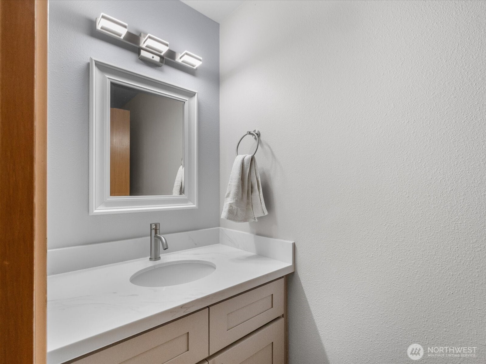21227 76th Avenue West, Unit B8 Edmonds, WA 98026 - Photo 6 of 29 a bathroom with a sink and a mirror