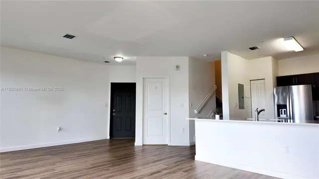 a view of a living room and wooden floor
